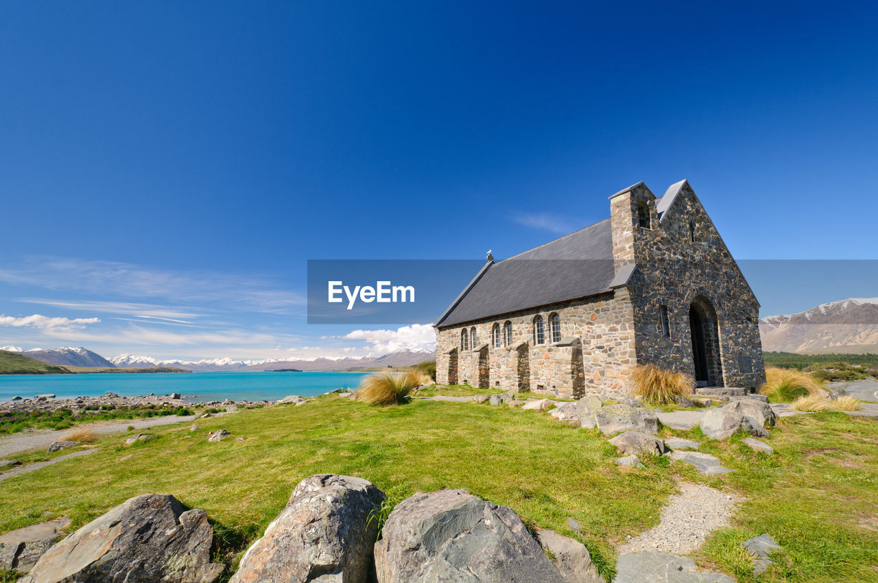 BUILDING BY SEA AGAINST SKY