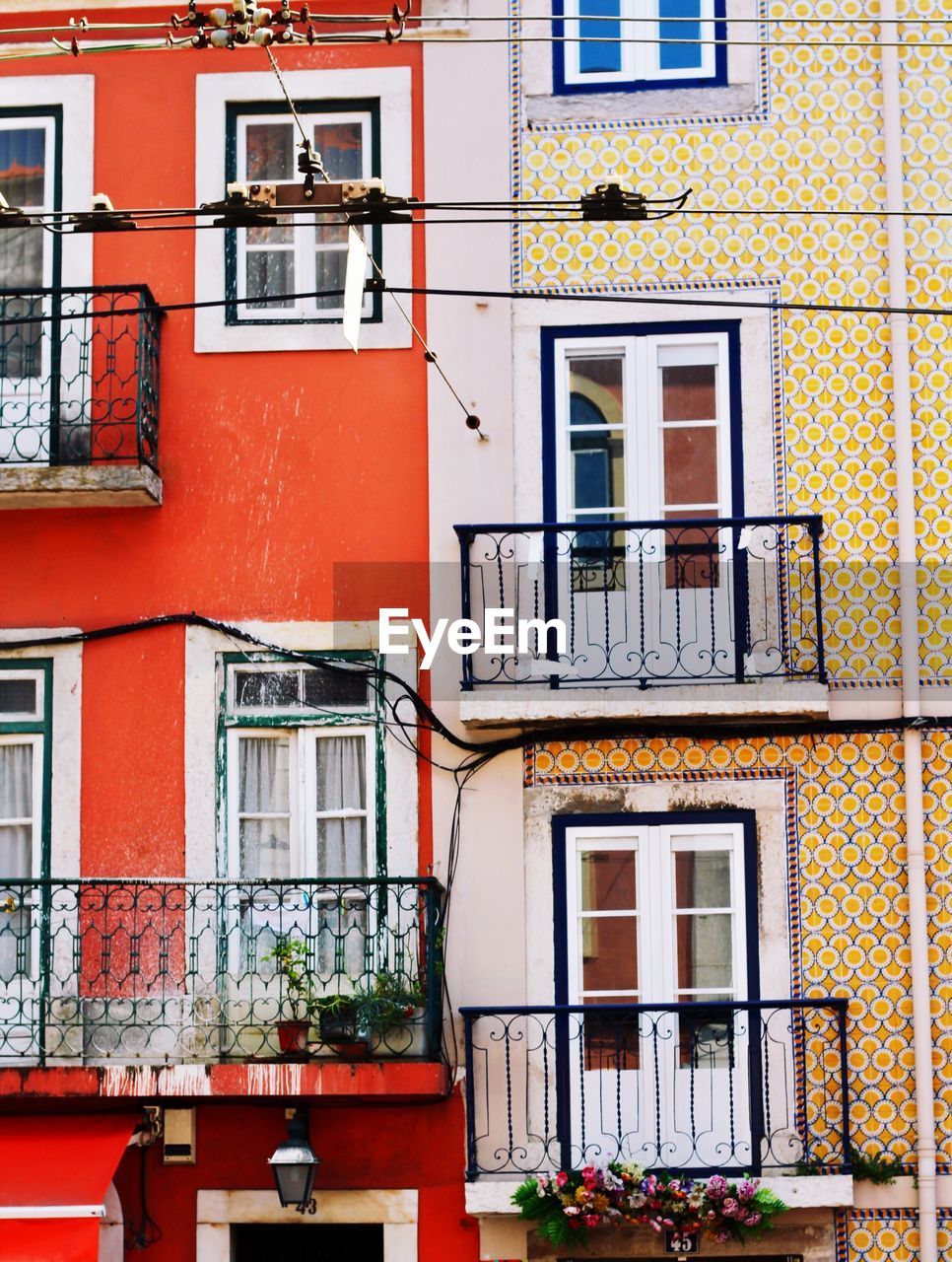 FULL FRAME SHOT OF BUILDING WITH MULTI COLORED WINDOWS