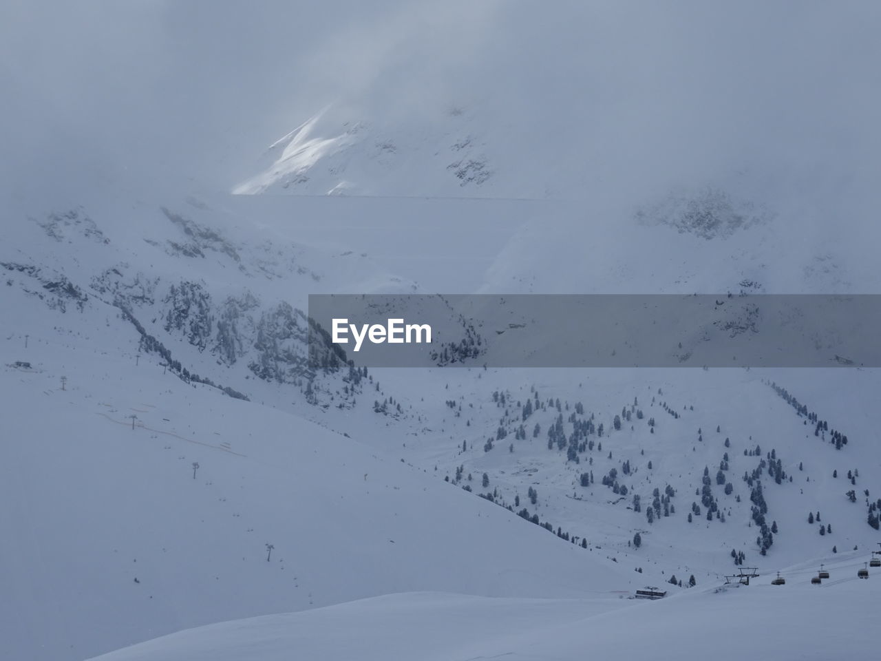 Aerial view of snow covered mountain against sky