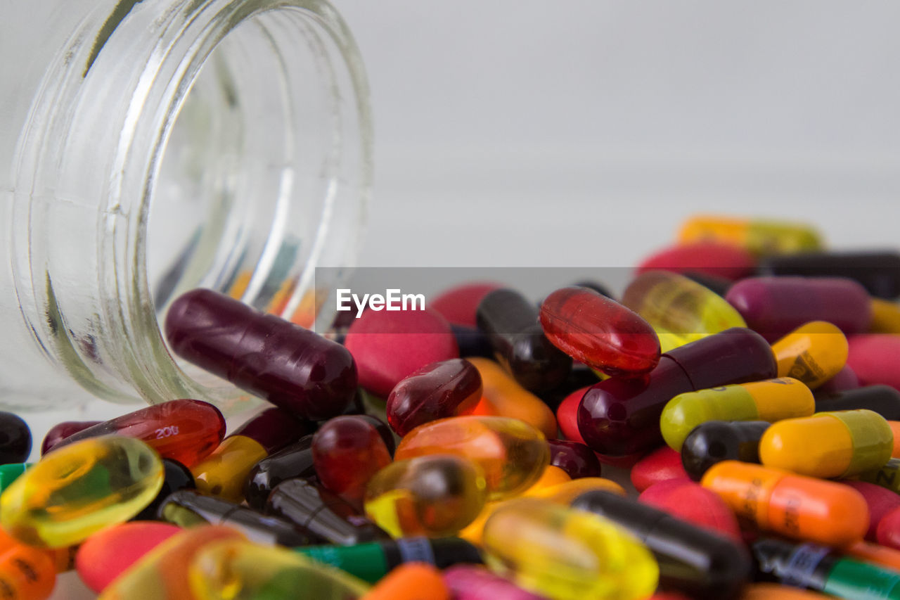 Close-up of multi colored capsules on table