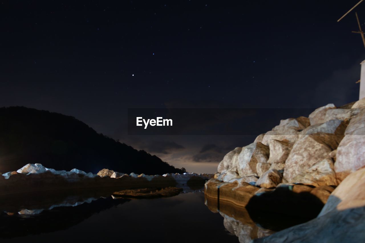 Scenic view of sea against sky at night