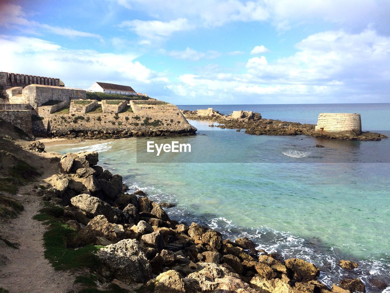 Scenic view of sea against cloudy sky