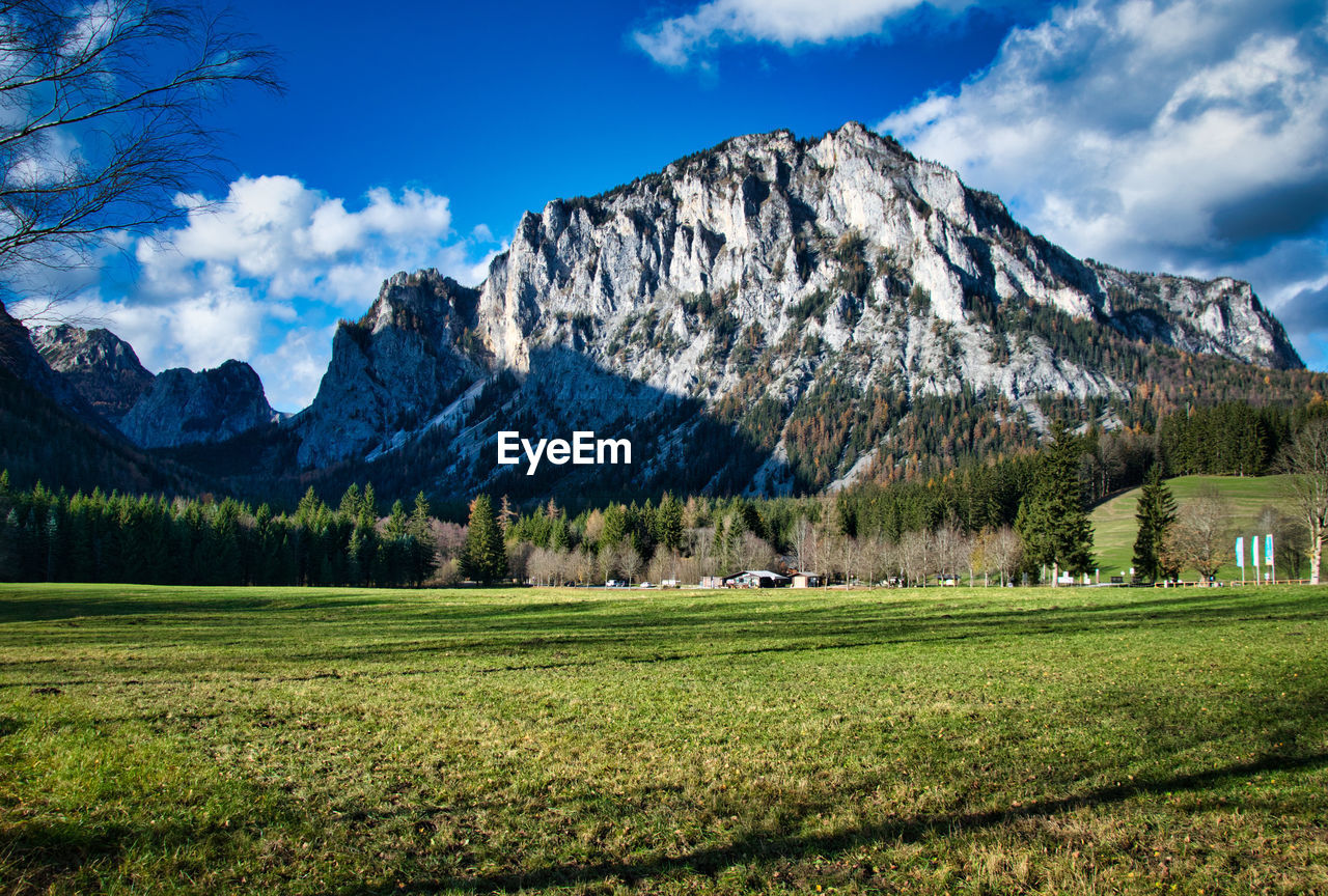 Scenic view of field and mountains against sky