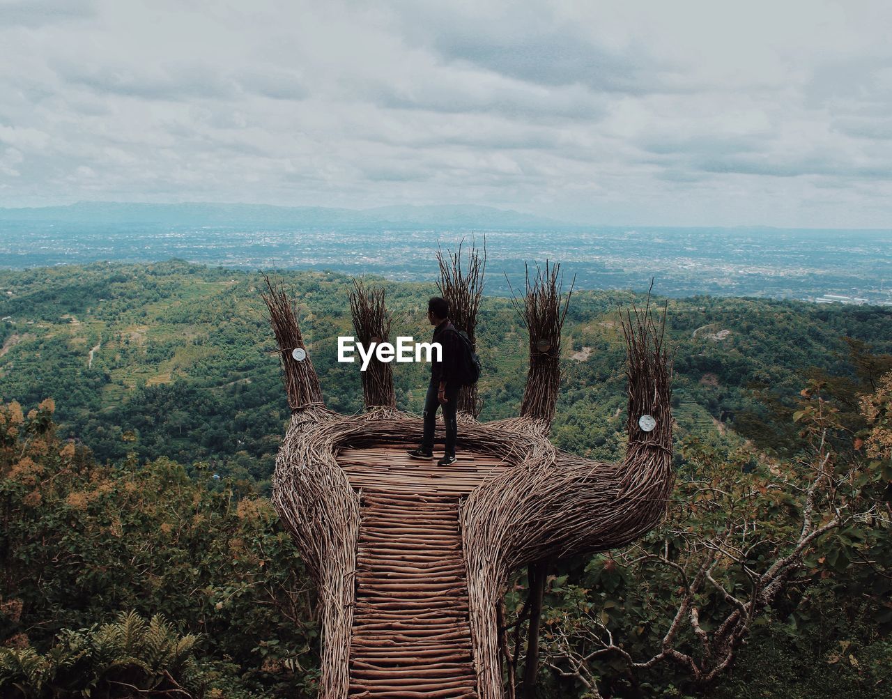 Rear view of people looking at landscape against sky