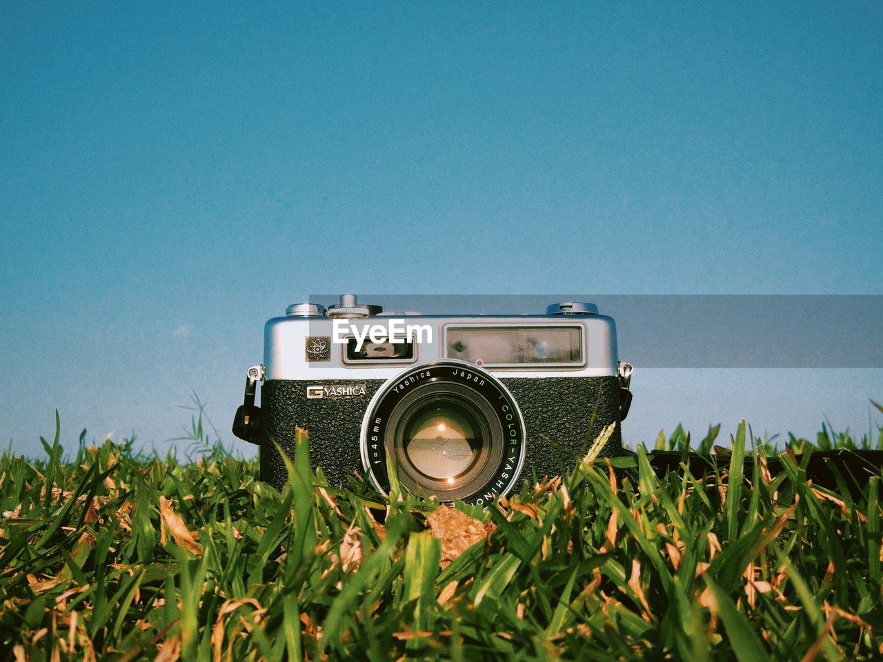 CAMERA ON FIELD AGAINST CLEAR SKY