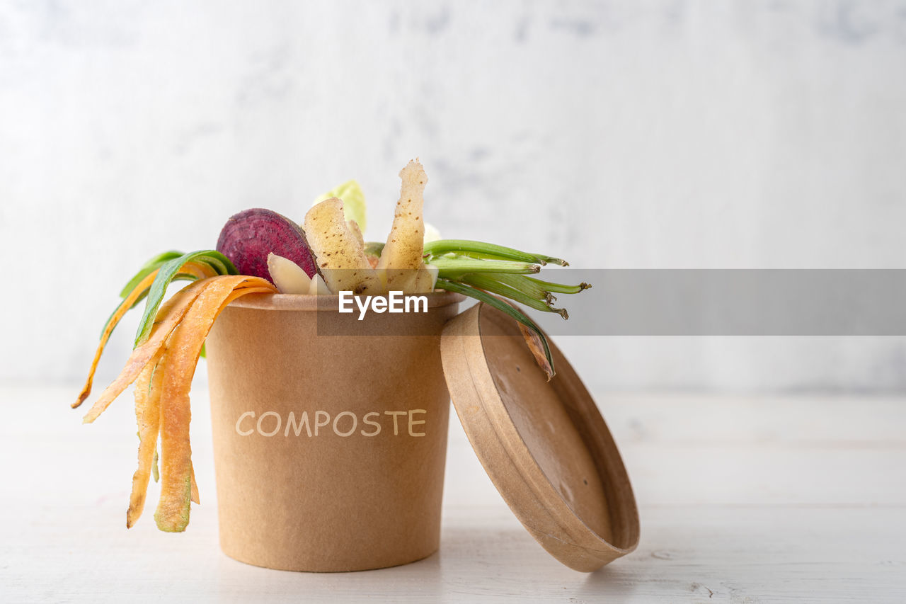 CLOSE-UP OF FRUITS SERVED ON TABLE AGAINST WALL