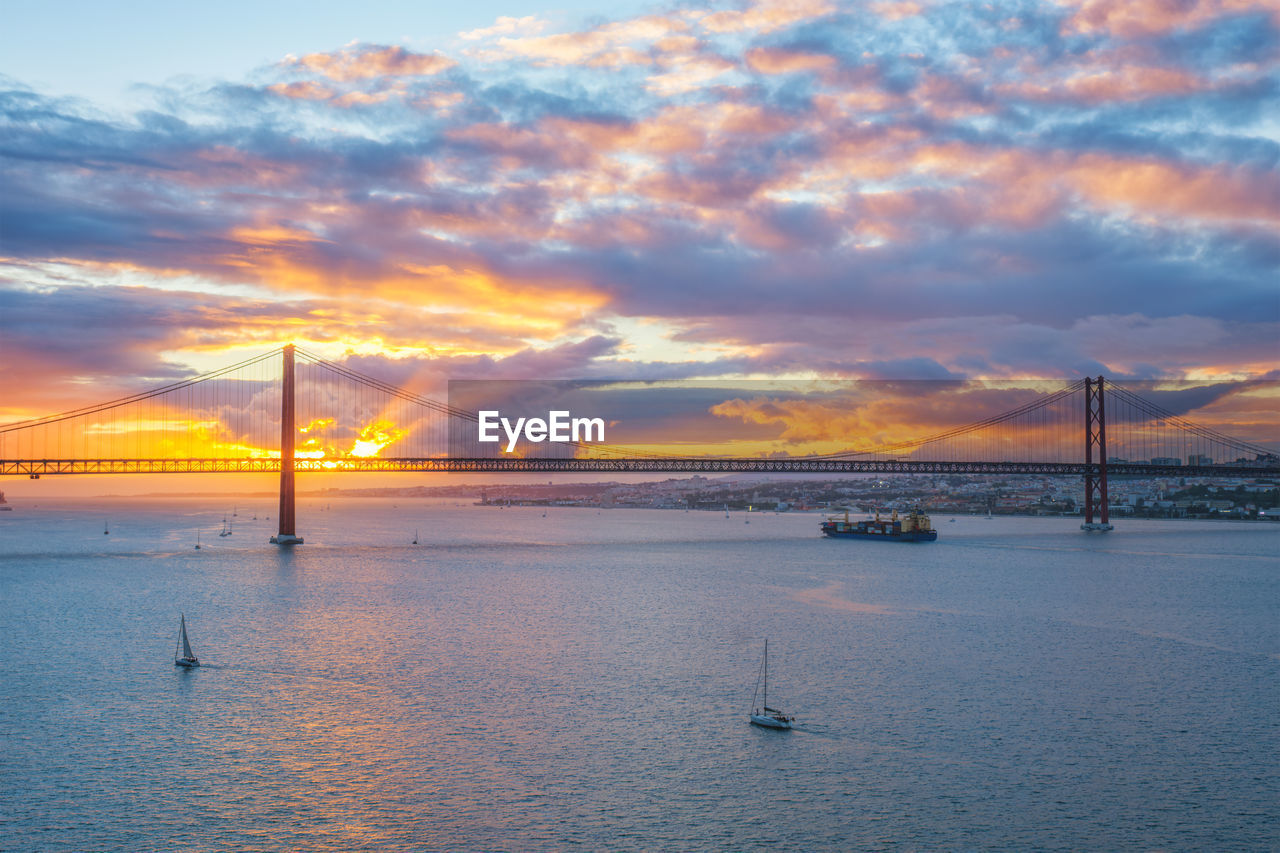 view of suspension bridge over river against sky during sunset