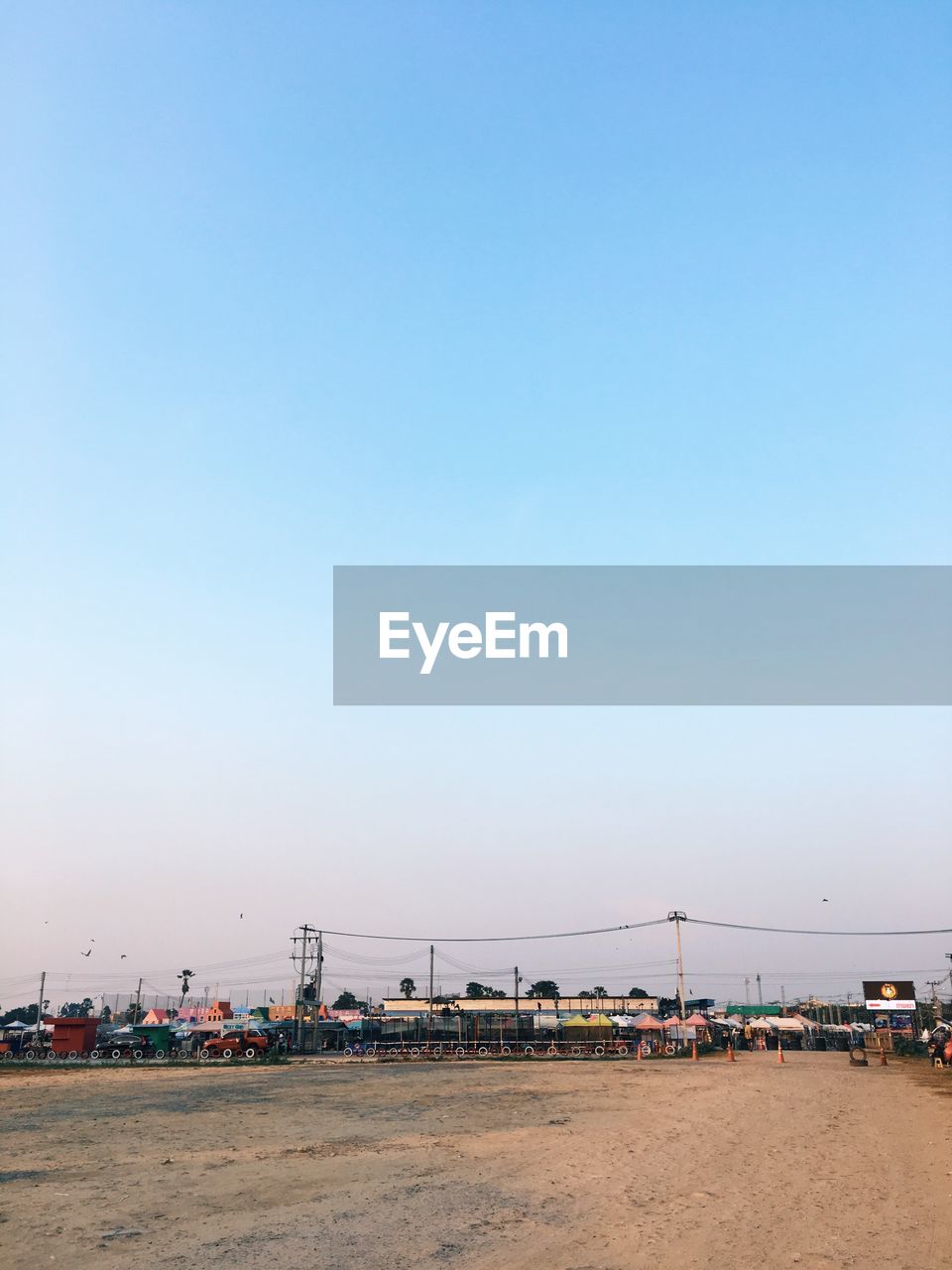 Scenic view of beach against clear blue sky