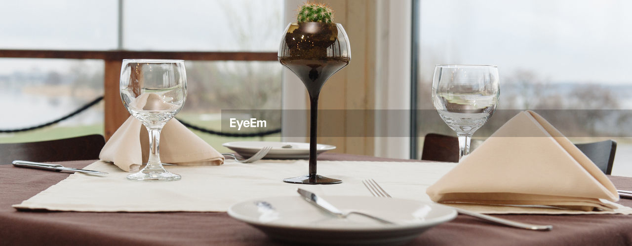 Drinking glass on table in restaurant