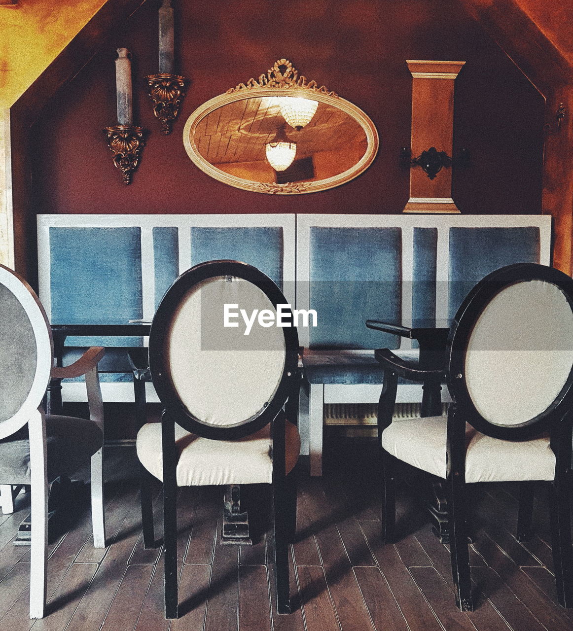 CLOSE-UP OF EMPTY CHAIRS AND TABLES IN CAFE