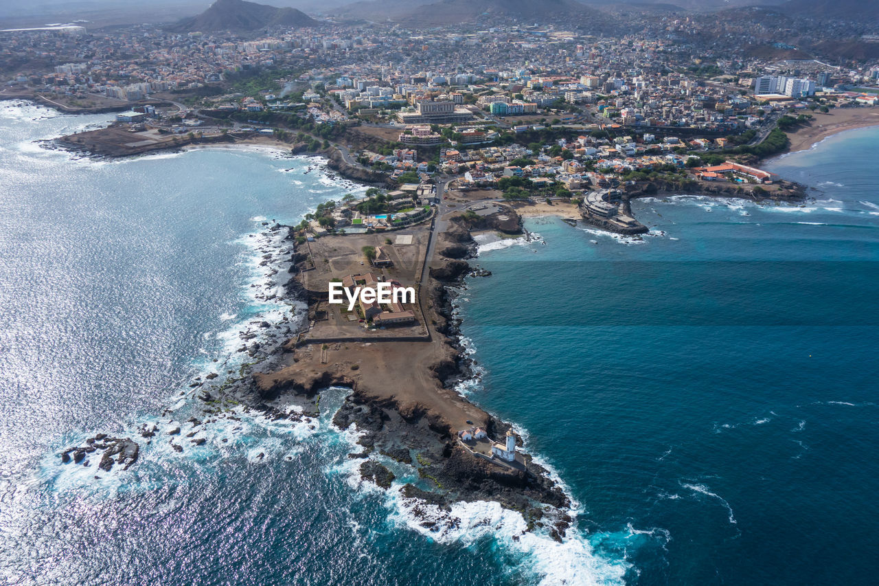 HIGH ANGLE VIEW OF CITY AT SEA