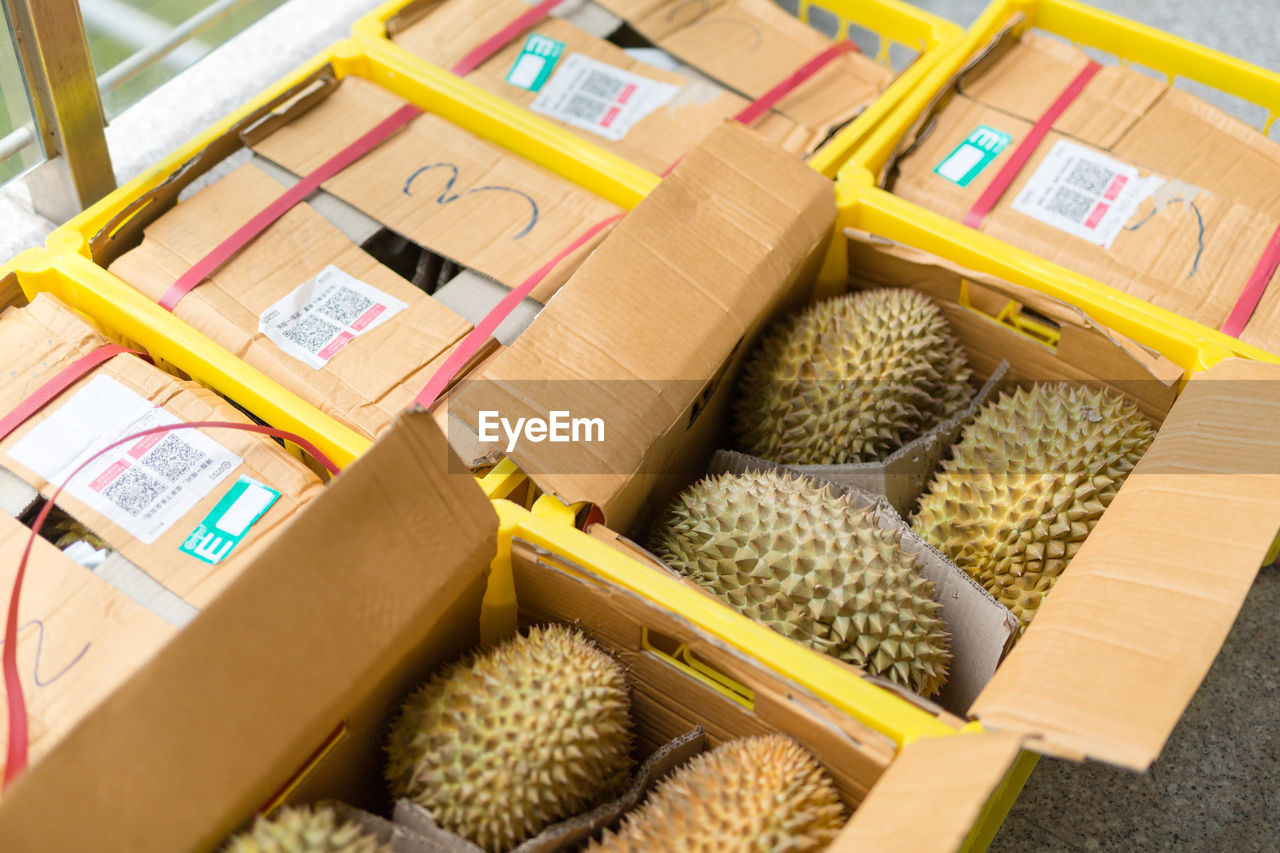 High angle view of fruits in boxes for sale at market