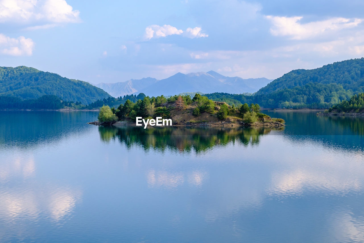 Scenic view of lake and mountains against sky