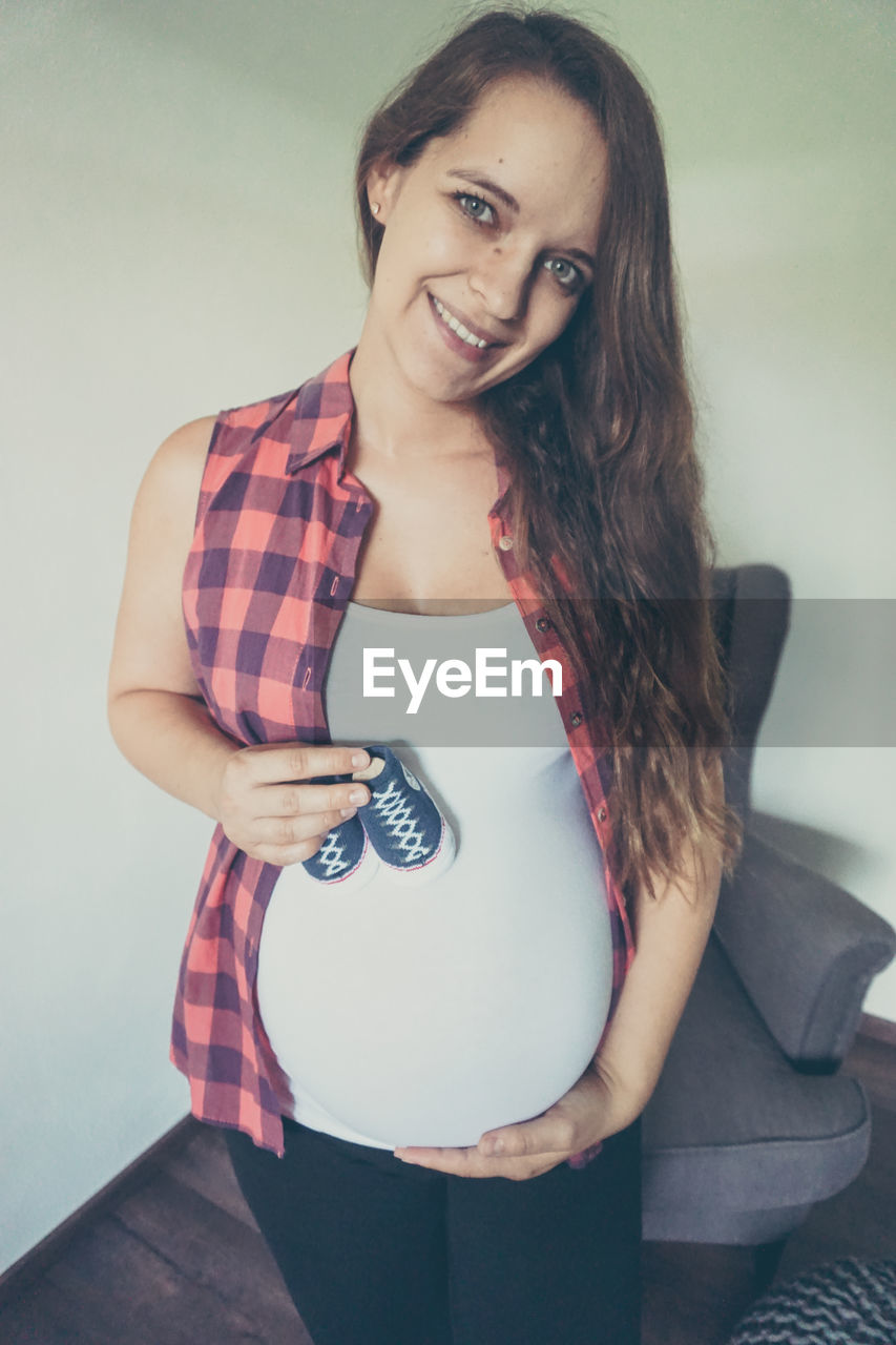 Pregnant woman standing at home