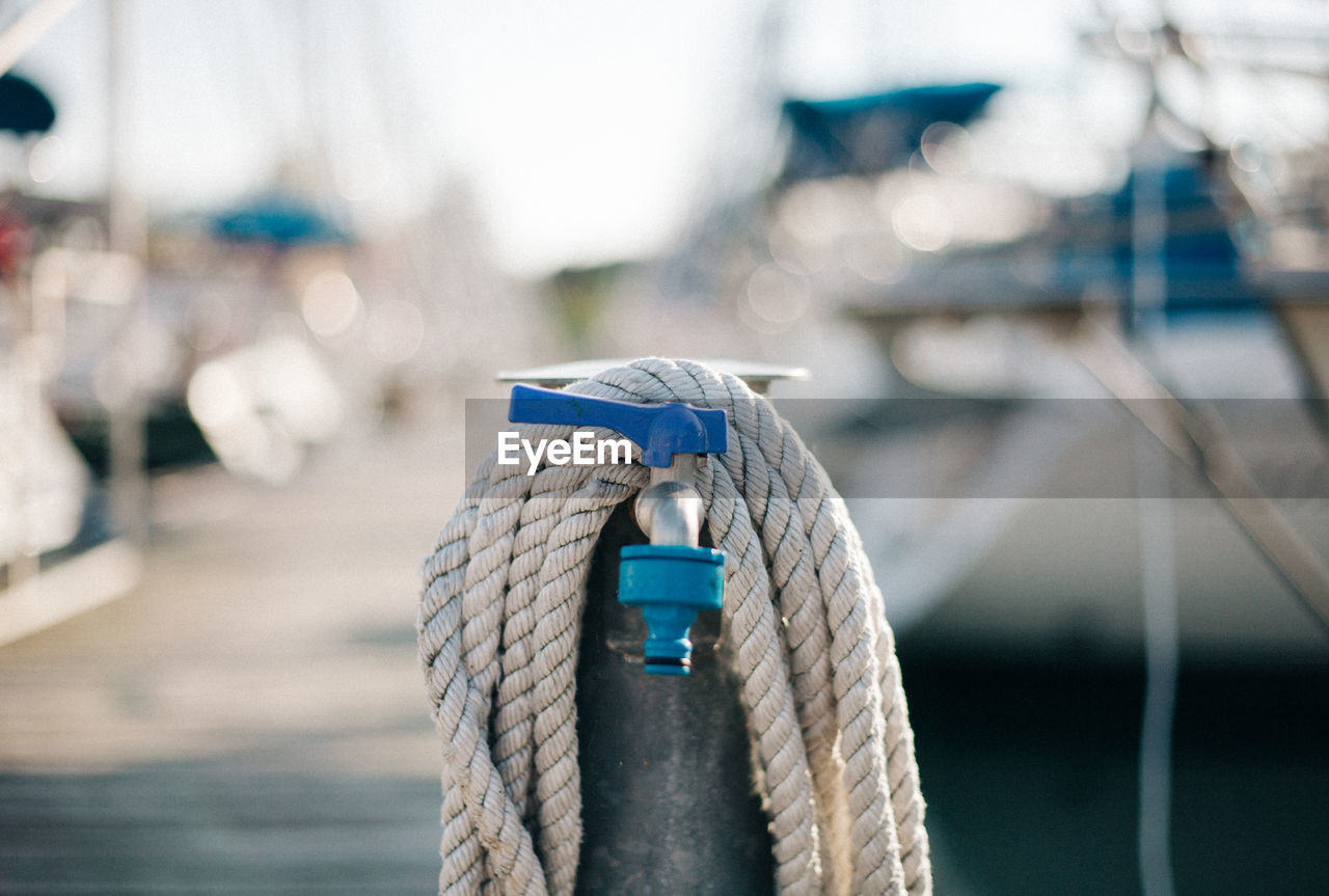 Close-up of rope tied to harbor