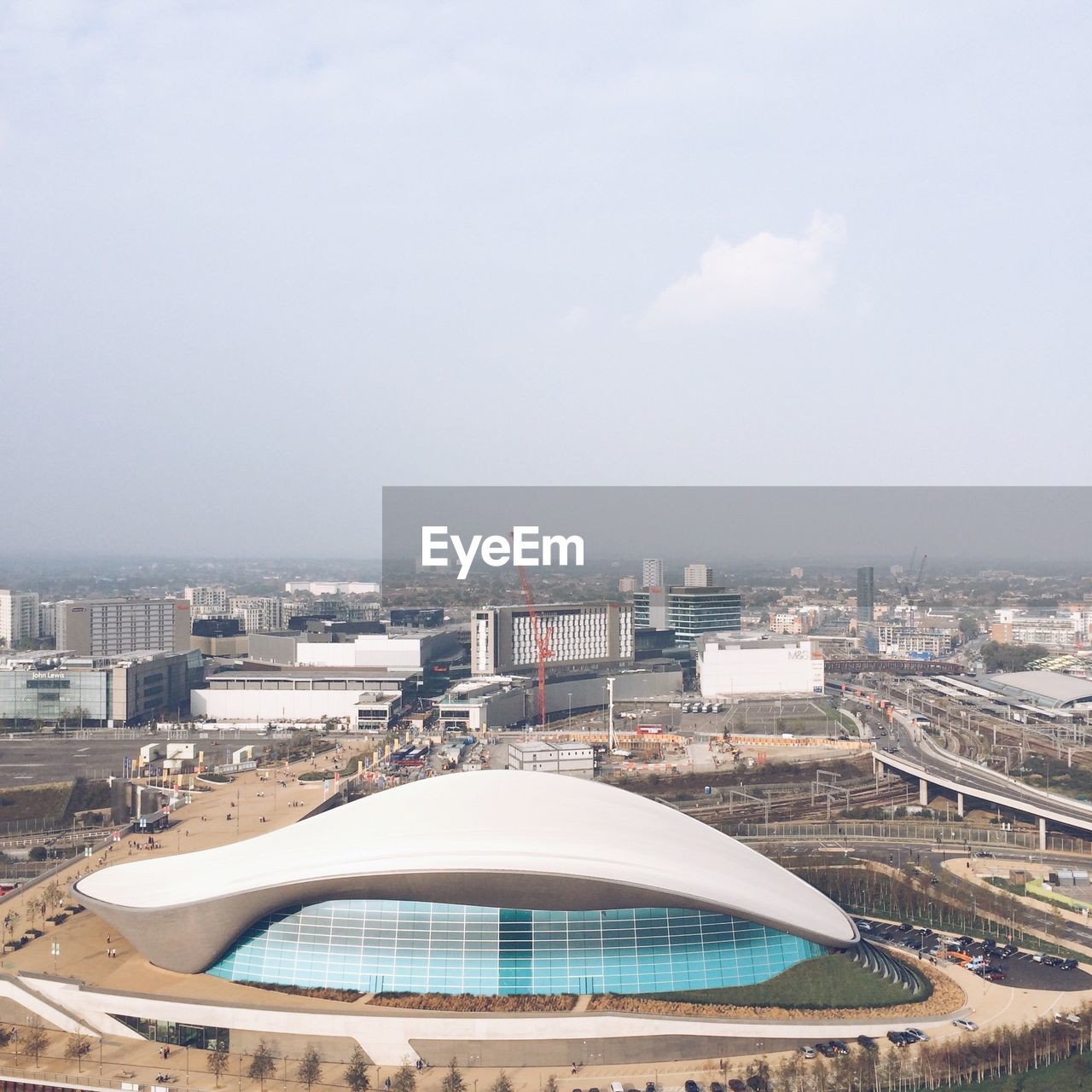 Aerial view of city against cloudy sky