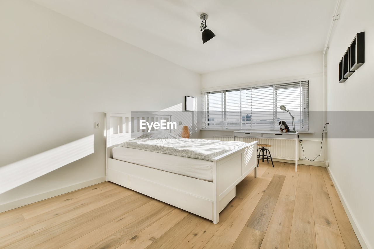 Man relaxing on hardwood floor at home