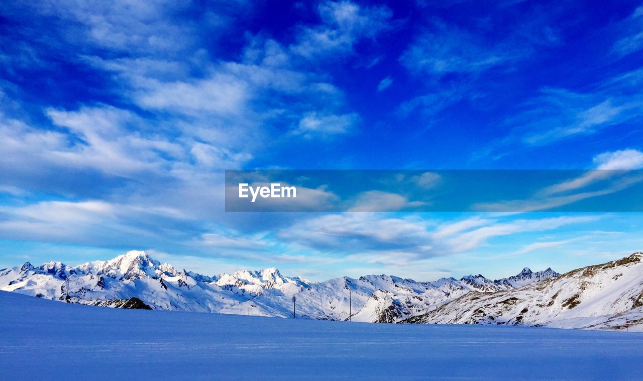 Scenic view of sea and snow covered mountains