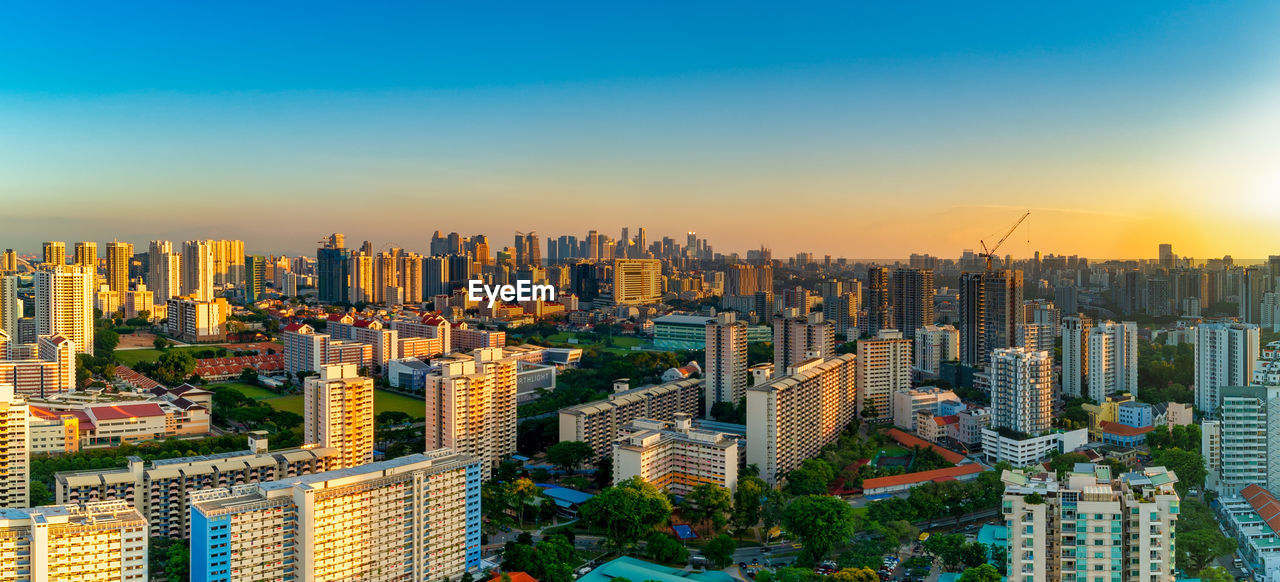 High angle view of modern buildings in city against sky