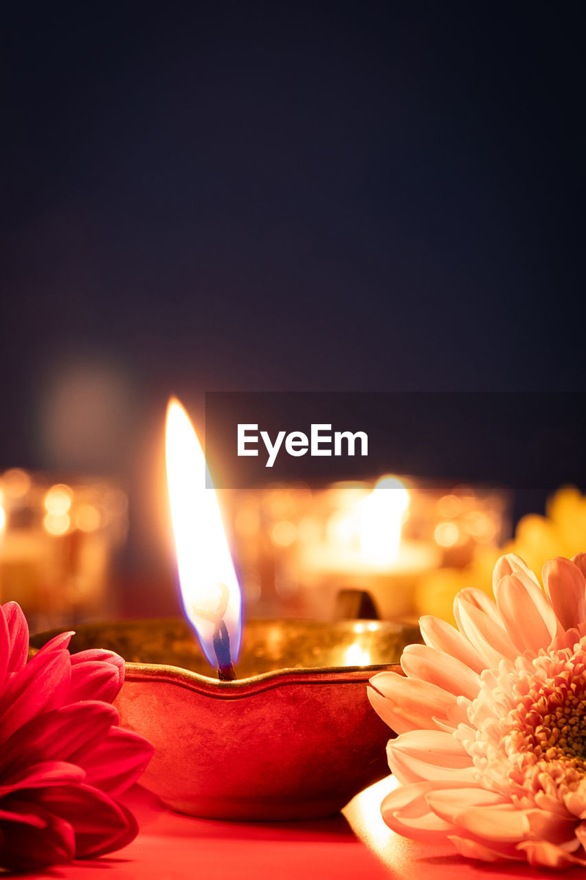 close-up of illuminated candles against black background