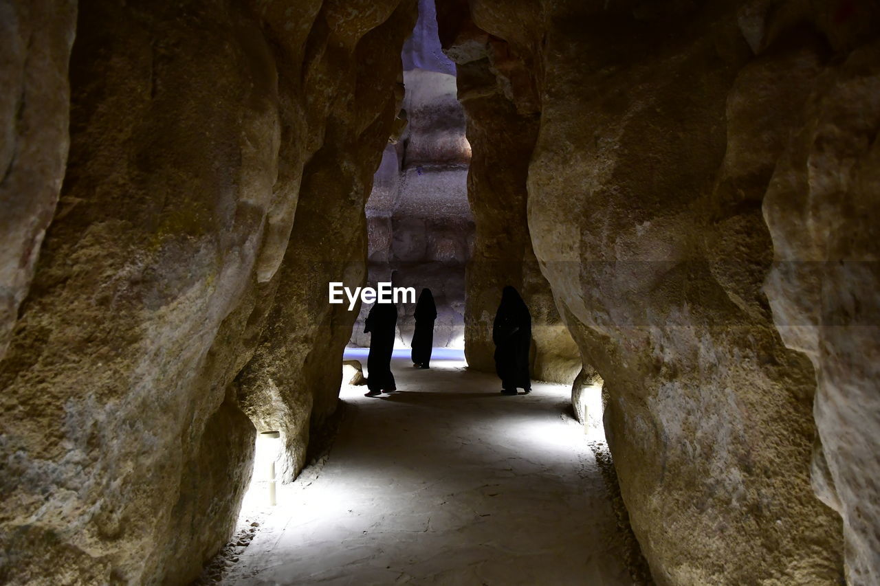 PEOPLE WALKING IN CAVE