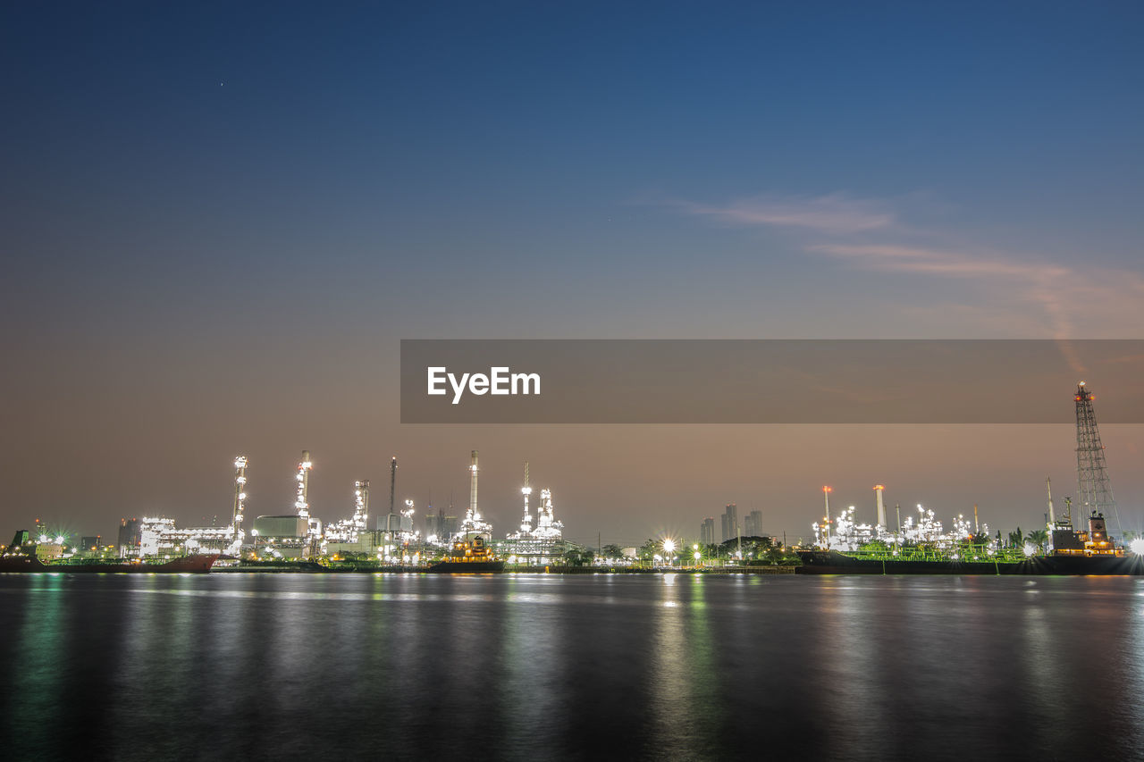 ILLUMINATED CITY AGAINST SKY AT NIGHT