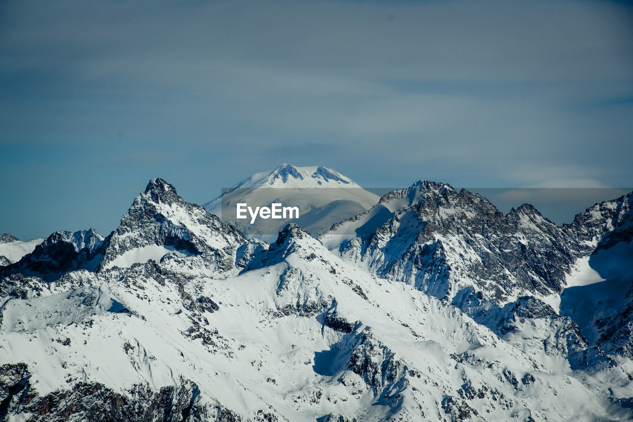 Scenic view of snowcapped mountains against sky