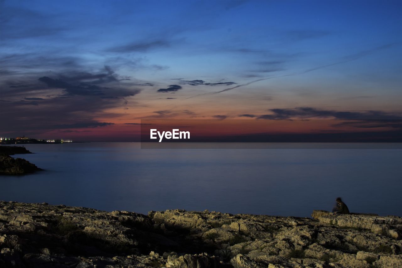 SCENIC VIEW OF SEA AT SUNSET