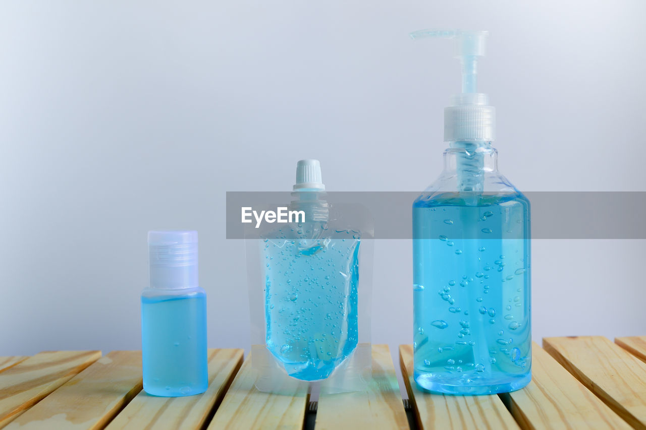 CLOSE-UP OF BOTTLES ON TABLE