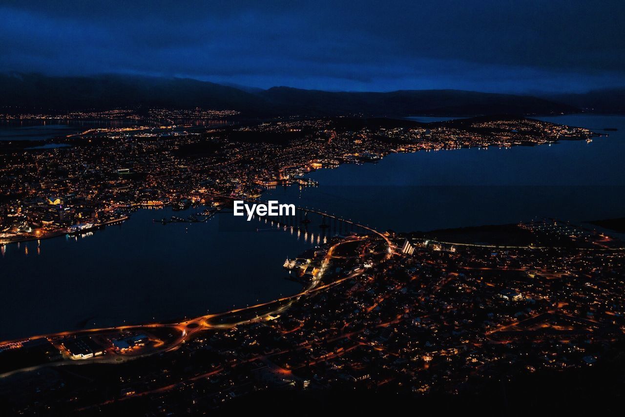 Aerial view of tromso bridge and illuminated cityscape at night