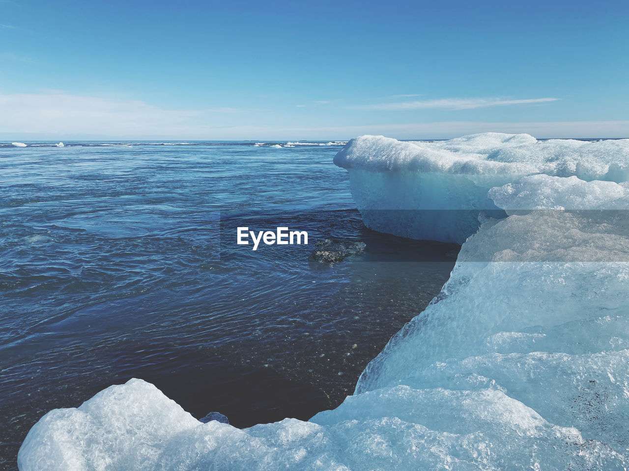 water, ice, sea, cold temperature, beauty in nature, snow, frozen, sky, winter, iceberg, scenics - nature, landscape, blue, nature, environment, ocean, glacier, sea ice, wind wave, freezing, polar ice cap, lagoon, melting, tranquility, tranquil scene, travel destinations, land, no people, outdoors, travel, day, non-urban scene, polar climate, ice cap, cloud, floating, horizon, wave, beach, floating on water, remote, idyllic, tourism, social issues