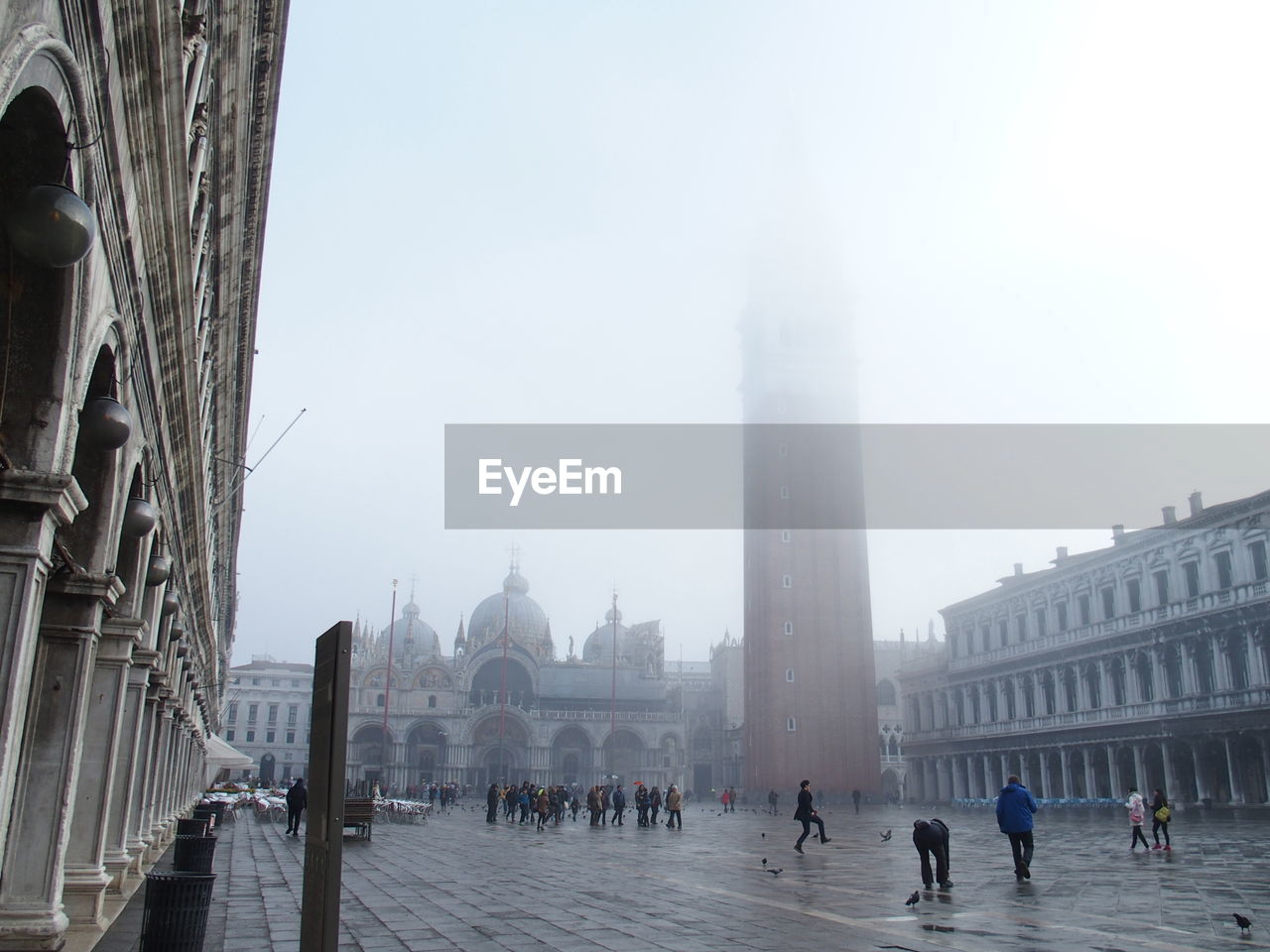 Tourists traveling at saint marks basilica in foggy weather