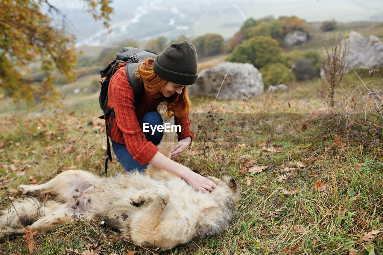 MAN WITH DOG ON GRASS