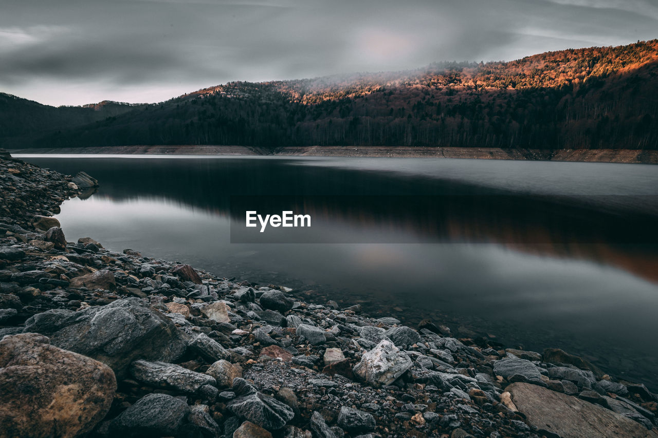 Scenic view of lake and mountains against sky