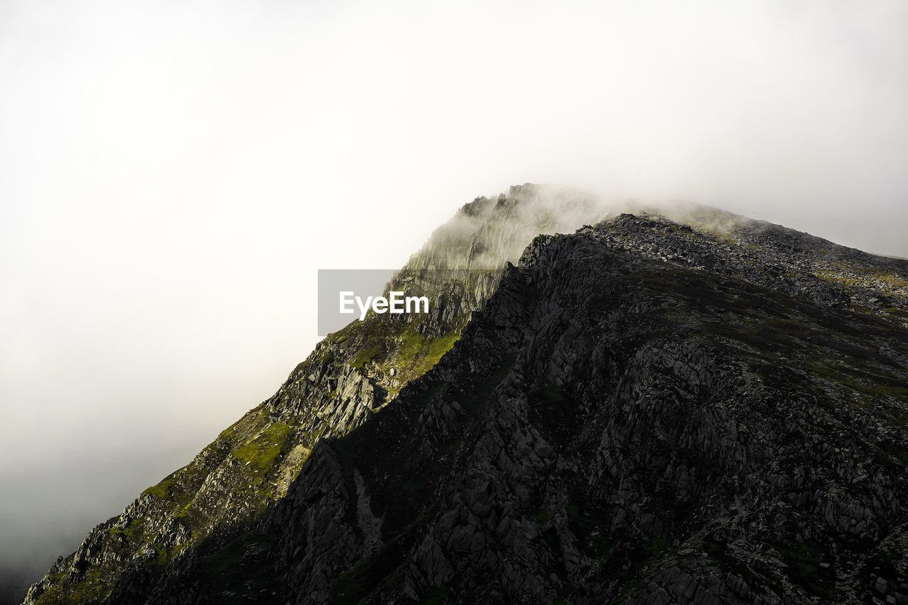 Low angle view of mountain range against sky