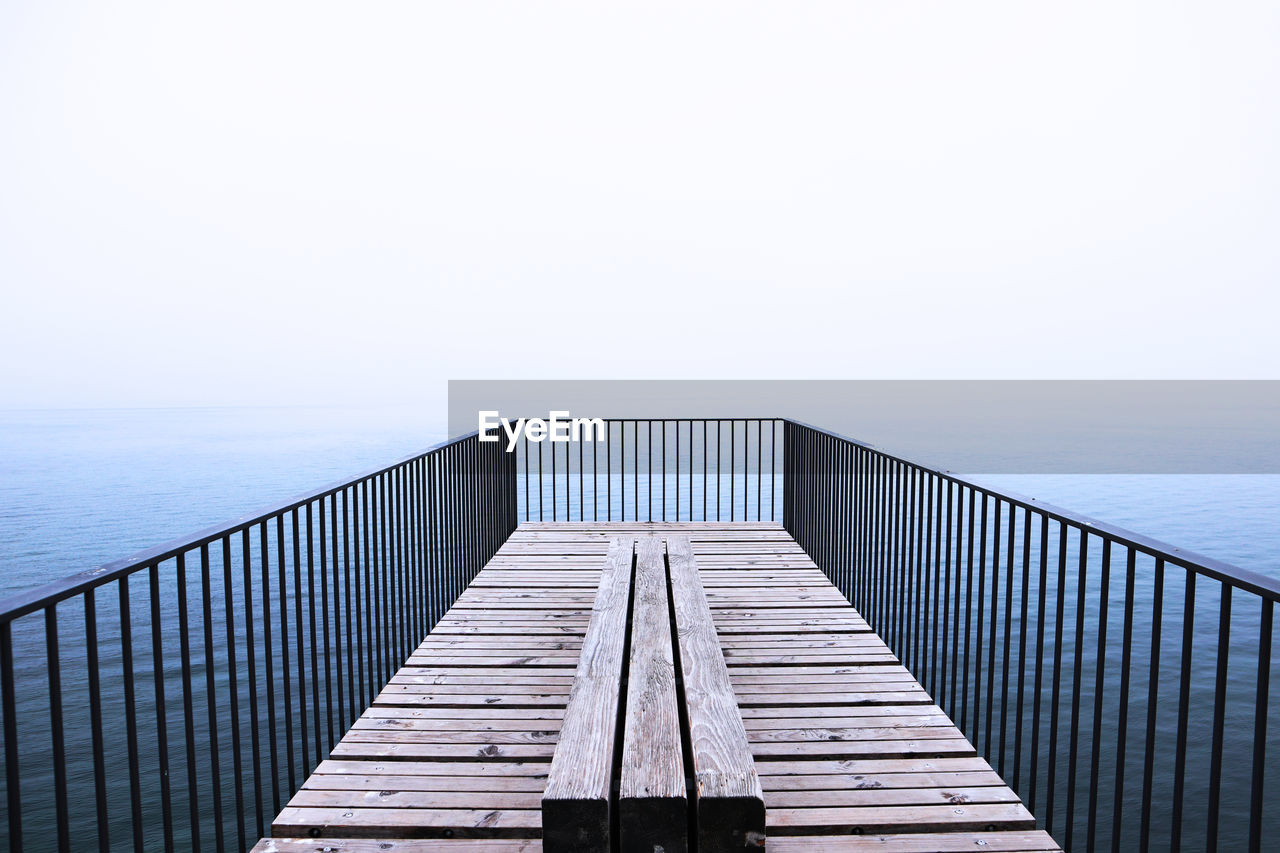 View of pier on sea against clear sky