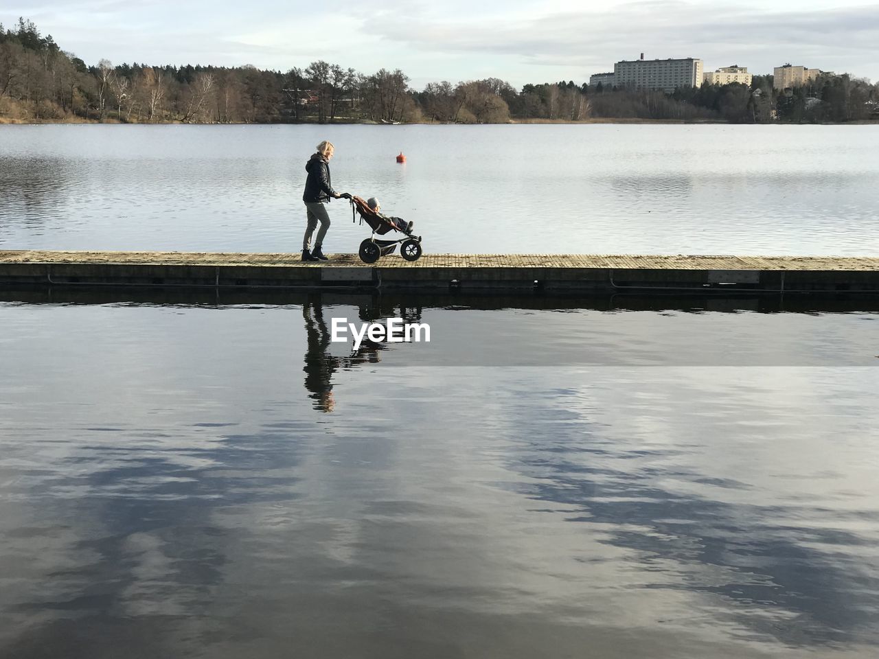 Man surfing in lake against sky