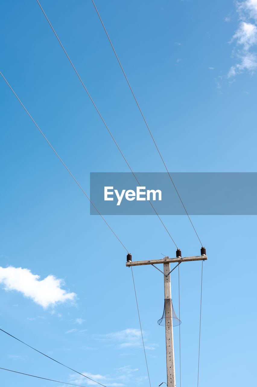 low angle view of power lines against sky