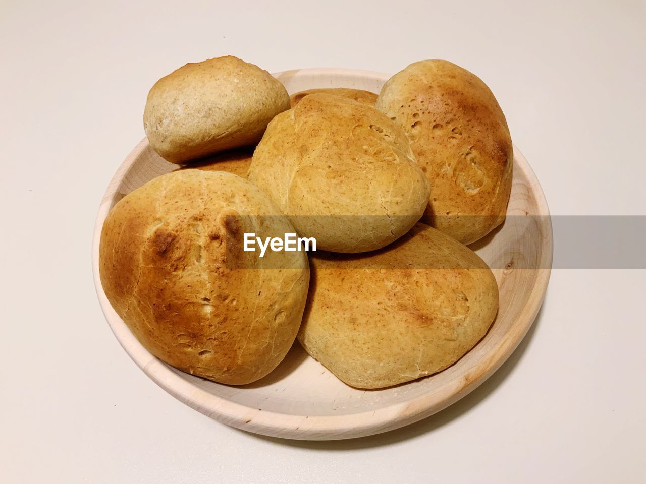 High angle view of bread in plate on white background