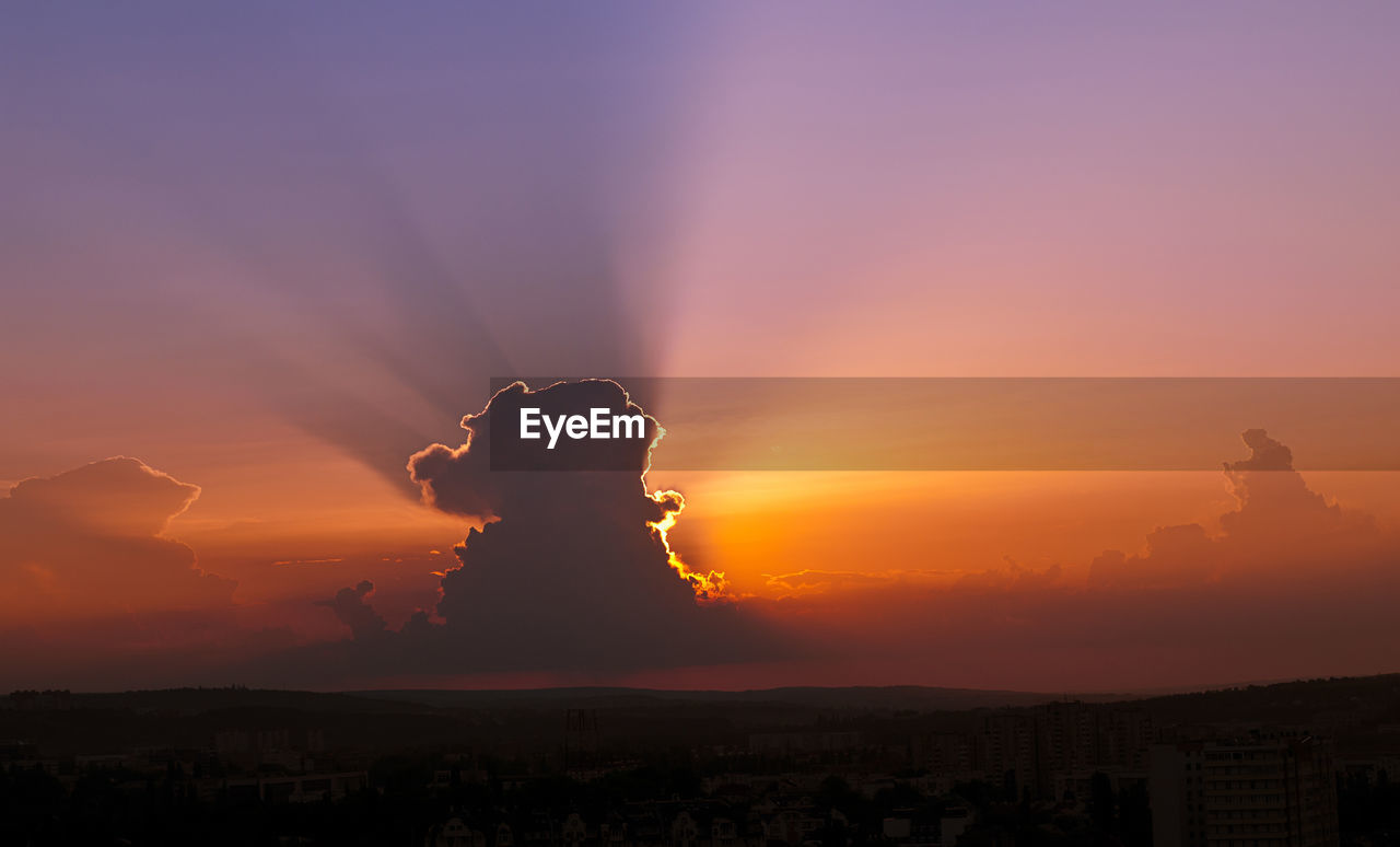 Dramatic sky over landscape during sunset