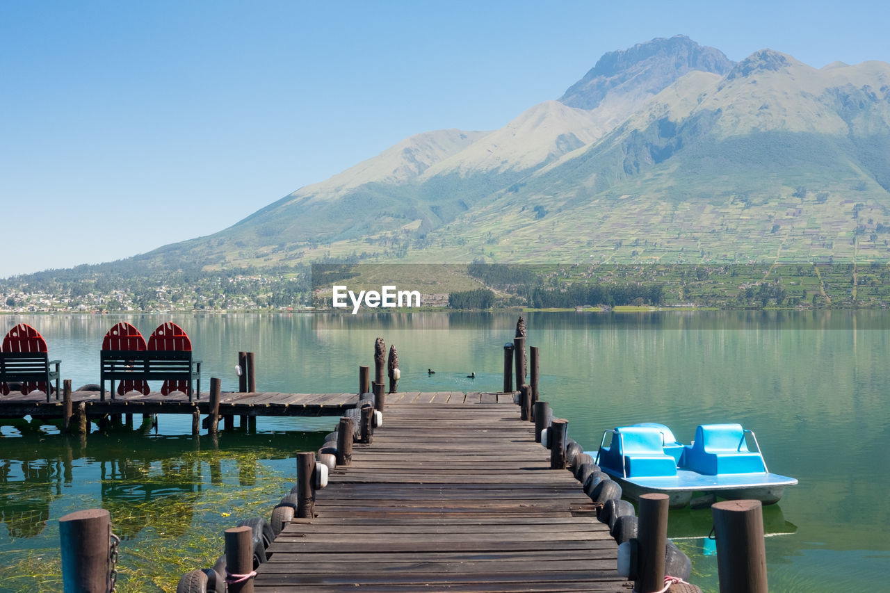 Jetty in lake against mountain