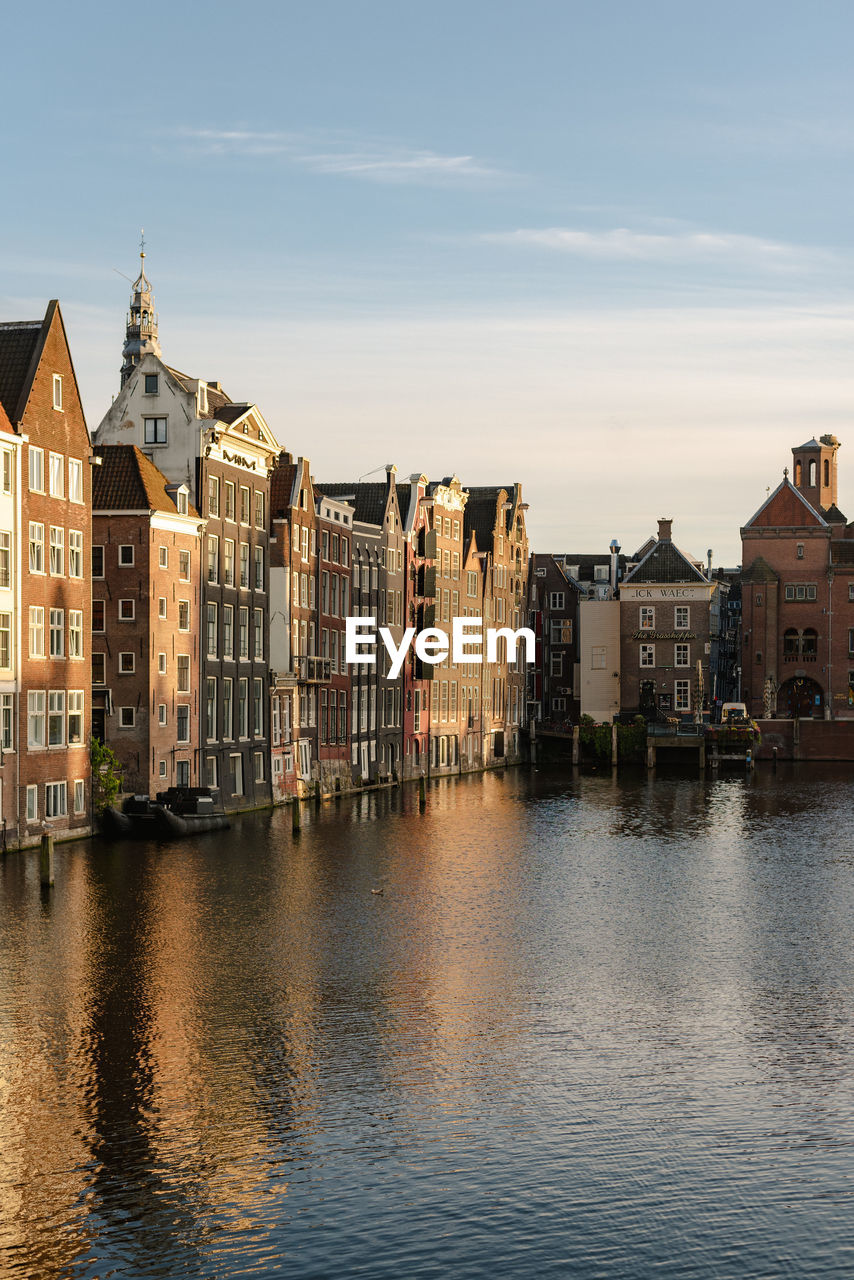 Historical buildings of amsterdam in the sunset light.