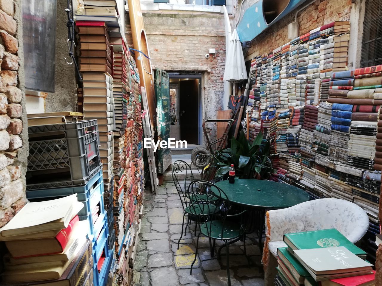 STACK OF BOOKS ON FLOOR