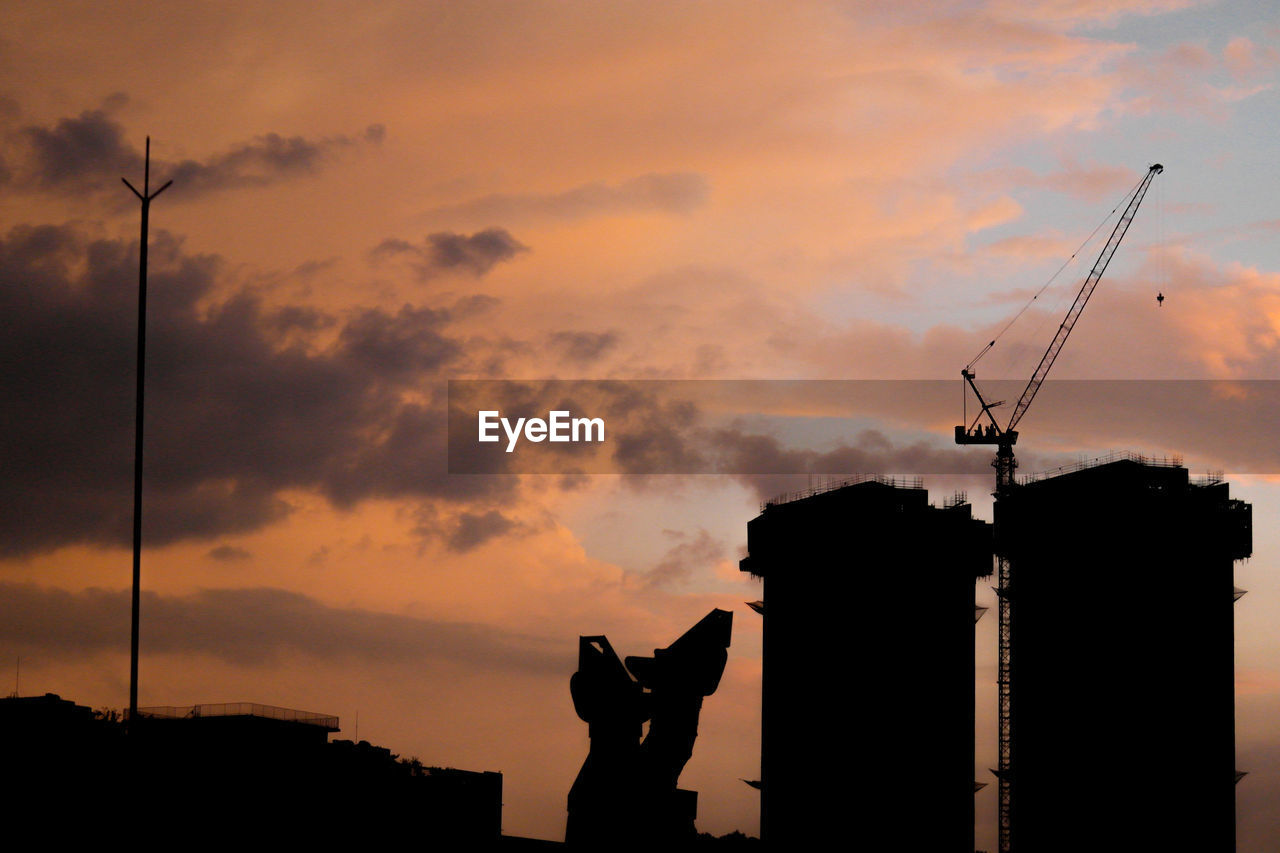 Silhouette of building structure against sky during sunset