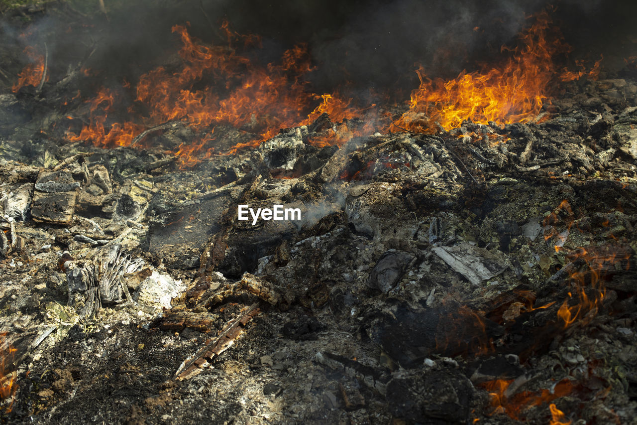 Fire in landfill. fire and smoke. burning garbage. lots of black smoke.