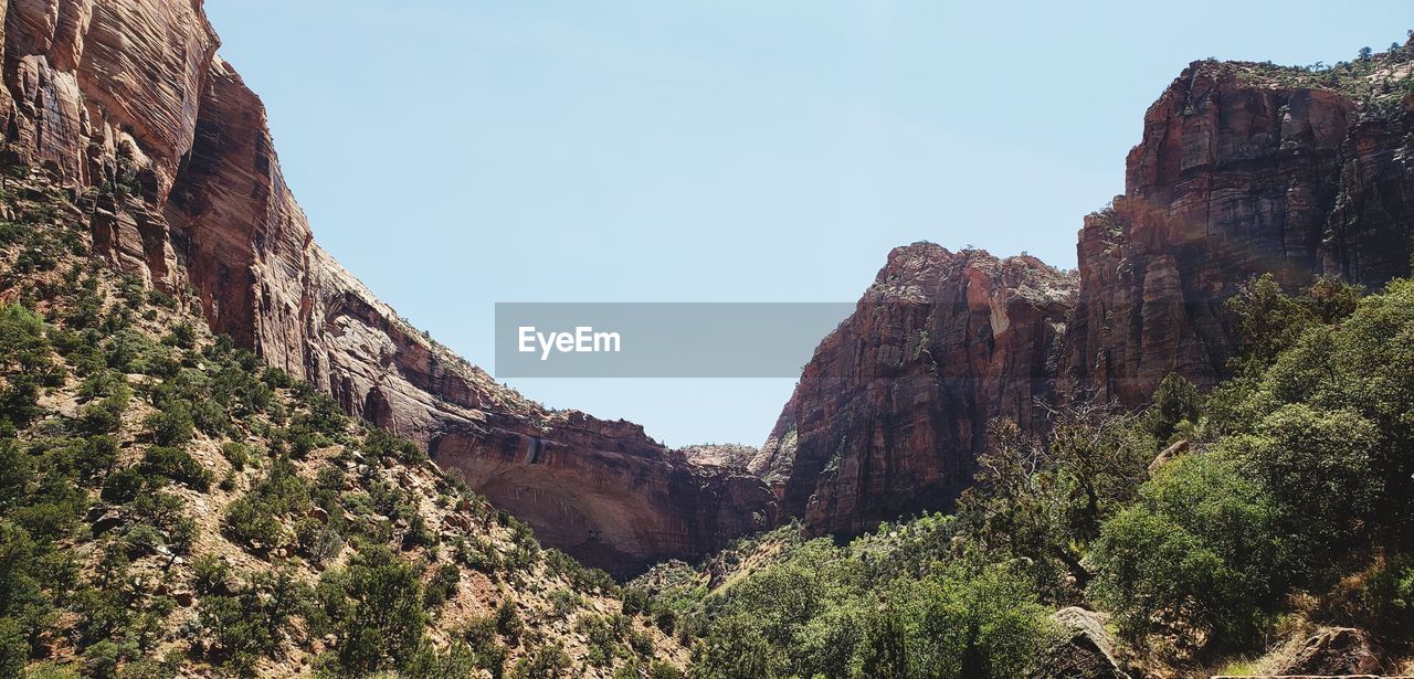 Low angle view of rock formations against sky