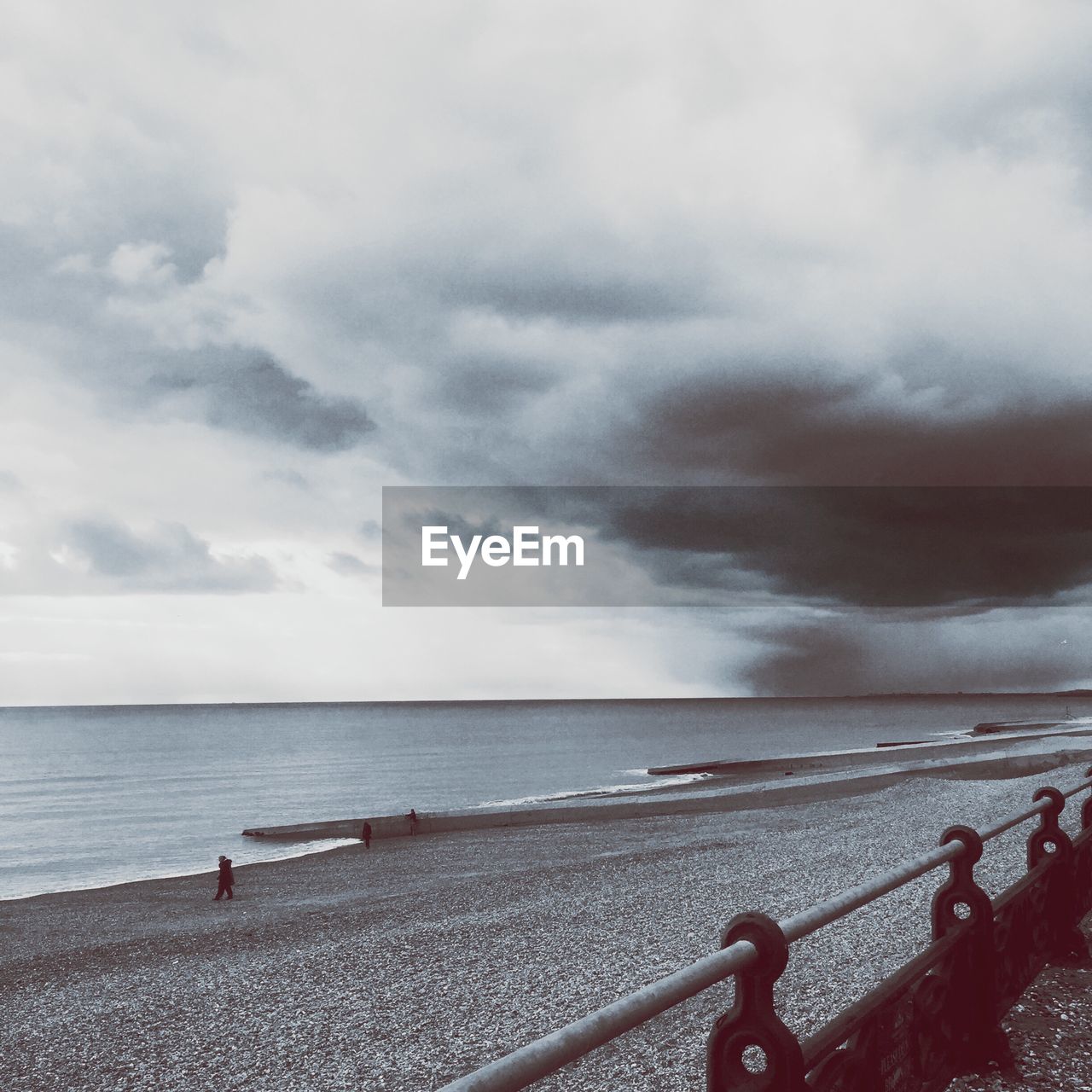 Scenic view of beach and sea against cloudy sky