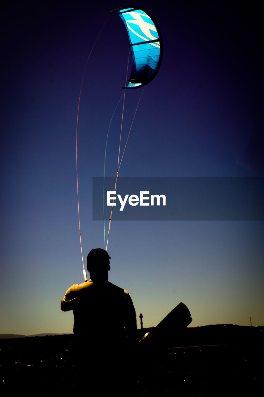 Man paragliding against sky