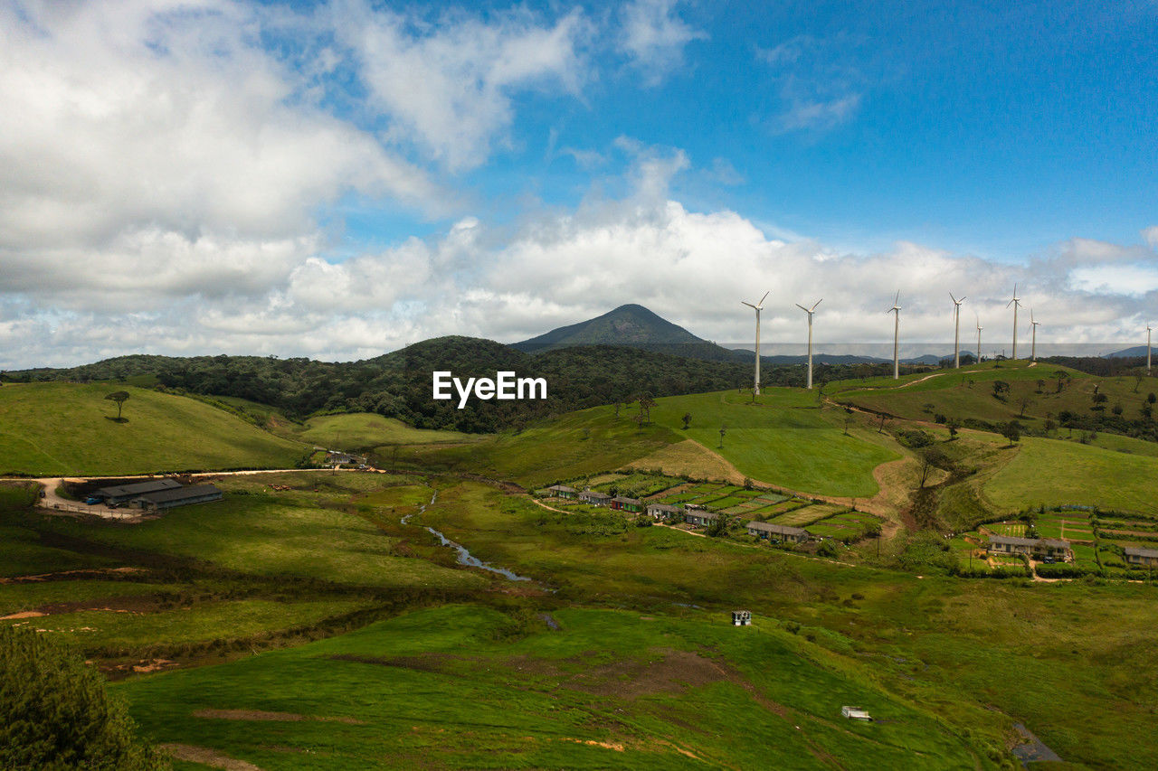 scenic view of agricultural field against cloudy sky