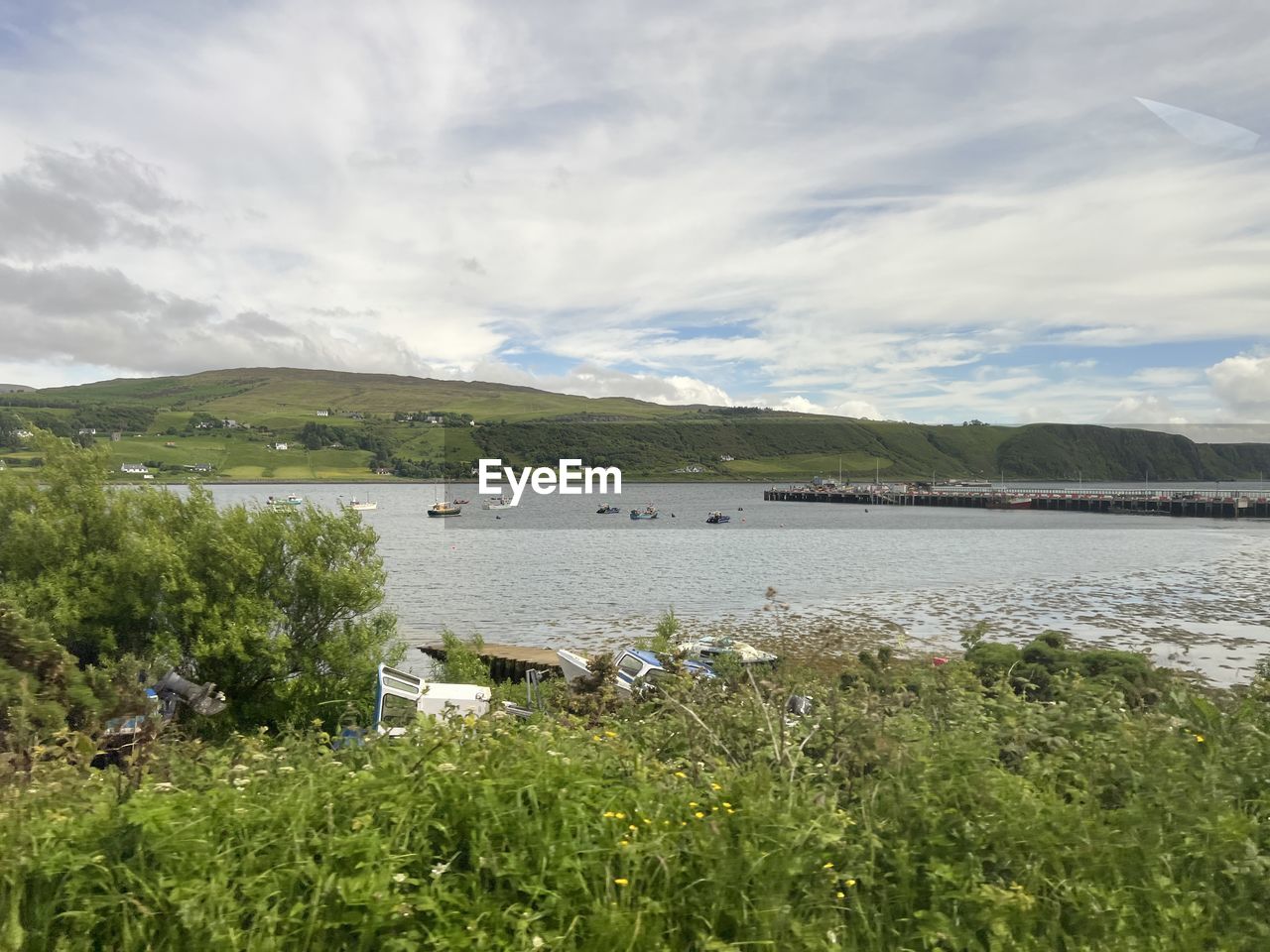 water, sky, plant, lake, environment, scenics - nature, cloud, nature, grass, landscape, beauty in nature, mountain, land, tranquility, shore, reservoir, no people, tranquil scene, coast, beach, travel destinations, rural area, day, green, body of water, travel, non-urban scene, outdoors, natural environment, mountain range, highland, meadow, tourism, wilderness, field, idyllic, nautical vessel, tree, rural scene, animal, summer, architecture, coastline, wetland